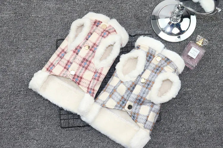 Front view of two plaid dog coats in pink and blue with white fleece lining, displayed on a grey background