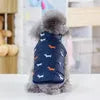 Dog wearing the Best Dog Snowsuit in blue with small dog patterns, viewed from the back.