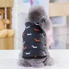 Back view of a dog wearing the Best Dog Snowsuit in blue with small dog patterns, sitting and looking back.