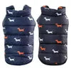 Two Best Dog Snowsuits in blue with small dog patterns, displayed side by side on a white background.