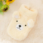 The Dog Face Cute Bear Dog Fur Coat in yellow, displayed on a fluffy surface.