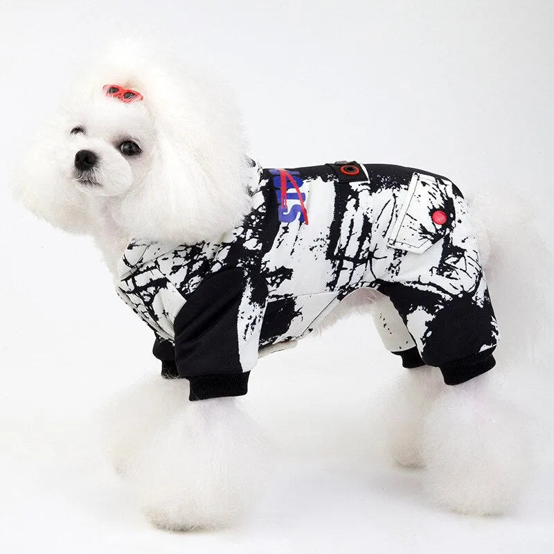 Side view of a white dog wearing a black and white patterned hoodie