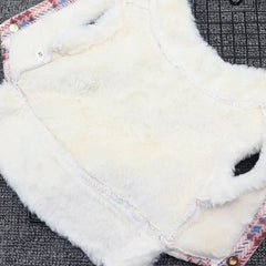 Close-up of the soft white fleece collar on a blue plaid dog coat