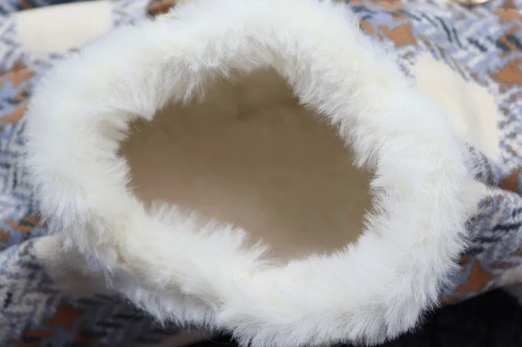 Detail view of the soft white fleece lining on a blue plaid dog coat