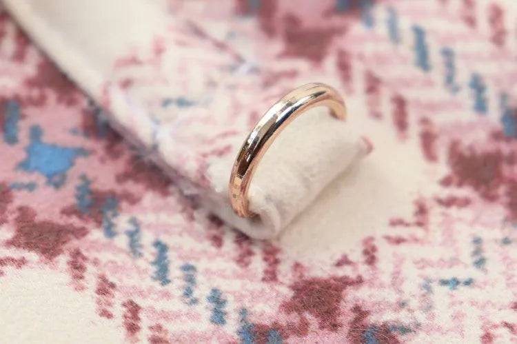 Close-up of the ring detail on a pink plaid dog coat with white fleece lining