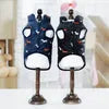 Two Best Dog Snowsuits in blue with small dog patterns, displayed on wooden stands, showing the interior design.