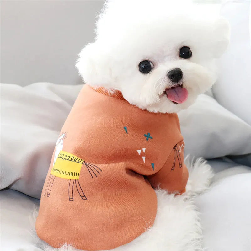 Adorable white dog wearing Cute Dog Shirts in orange with a horse print, showcasing a bright and charming outfit.