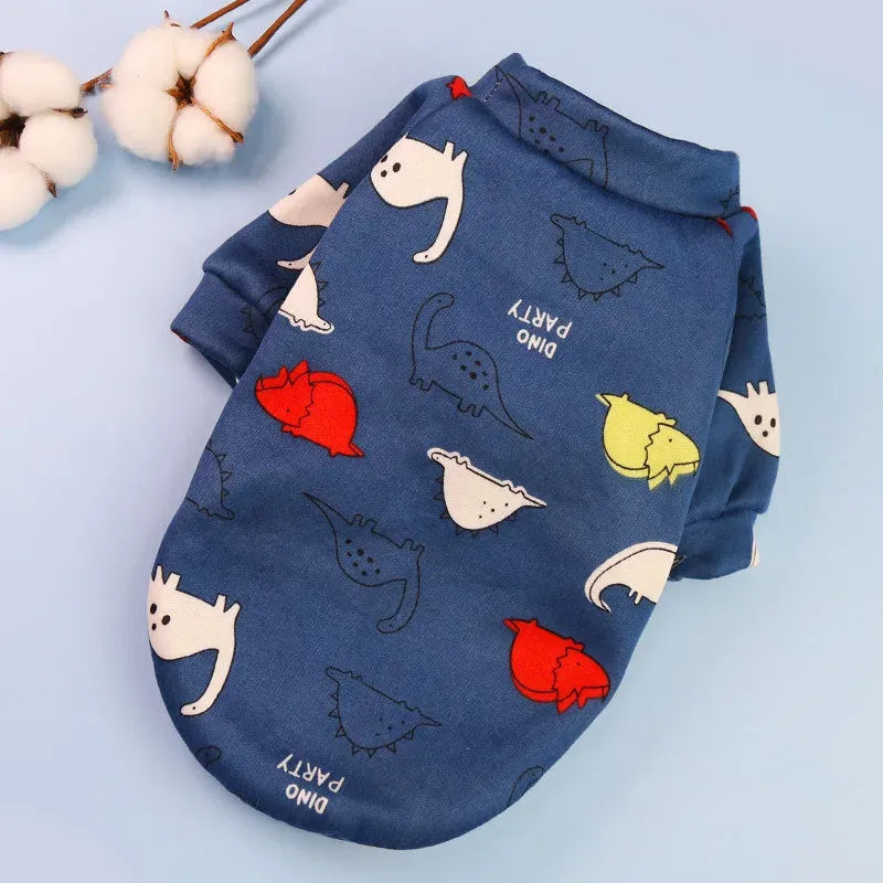 Designer Dog Coat in blue with cute dinosaur prints, great for a fun and unique look.