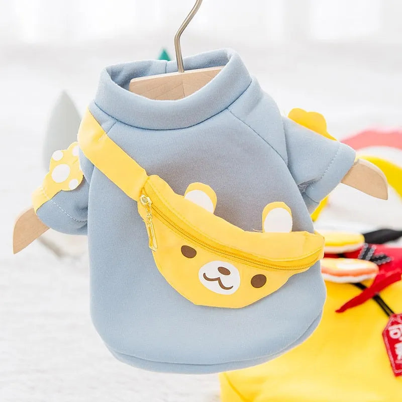 Light blue sweater with a yellow bear-shaped satchel, perfect as Designer Dog Sweaters."