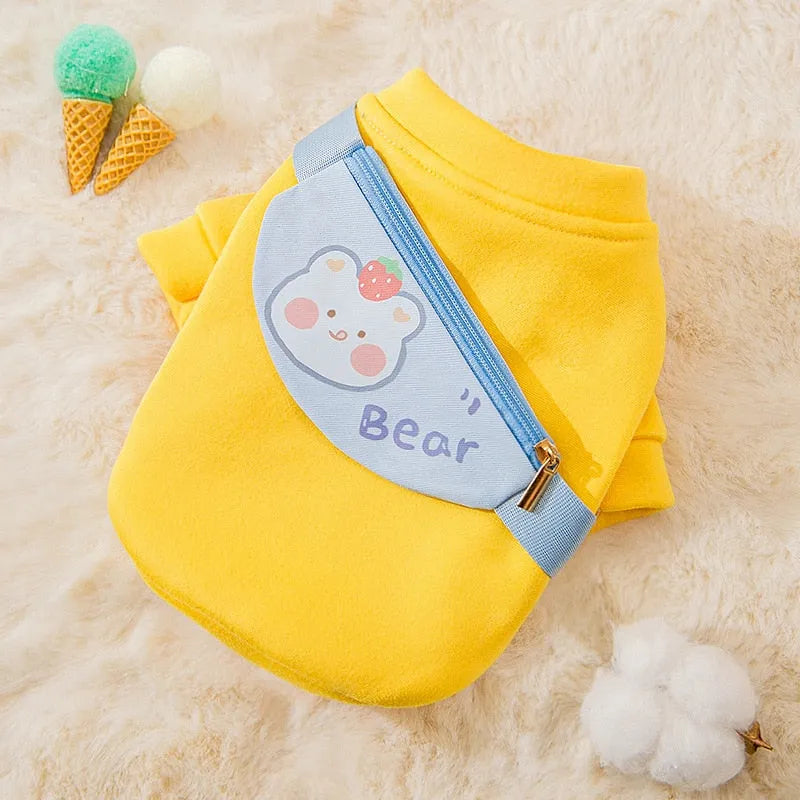 "Yellow sweater with a blue bear-shaped satchel, perfect as Designer Dog Sweaters."