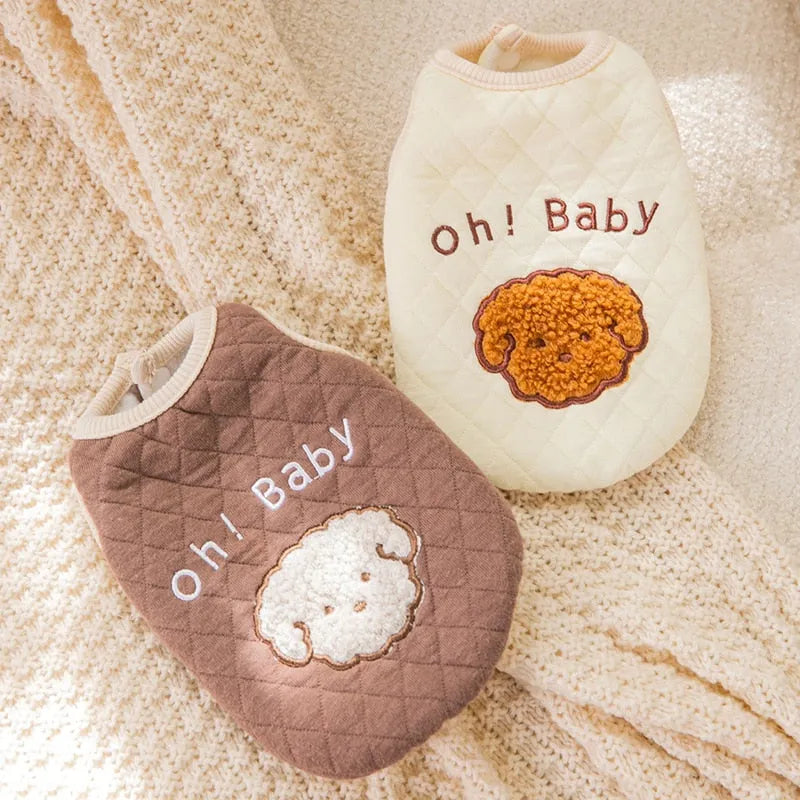 Two 'Oh! Baby' sweaters laid out, one in brown and the other in cream, featuring embroidered dog faces, perfect for Dog Thanksgiving Sweaters."