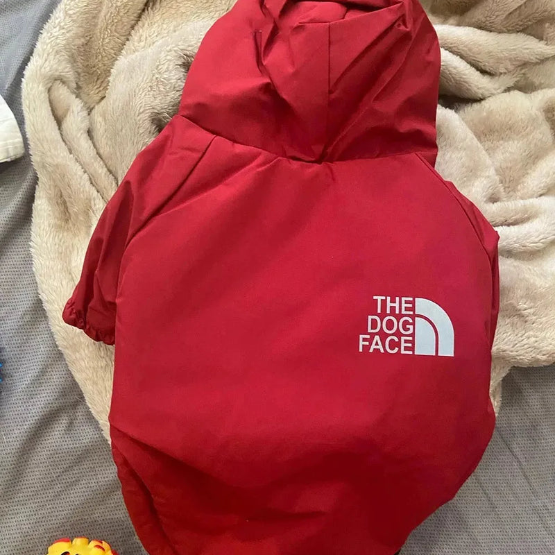 Red "The Dog Face" raincoat for dogs, highlighting durable and stylish waterproof dog apparel.