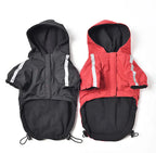 Black and red dog raincoats with hoods, displayed side by side, perfect waterproof outerwear for dogs.