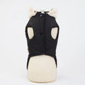 A black fleece dog jacket with button closures, displayed on a mannequin, showing the back view with faux fur trim.