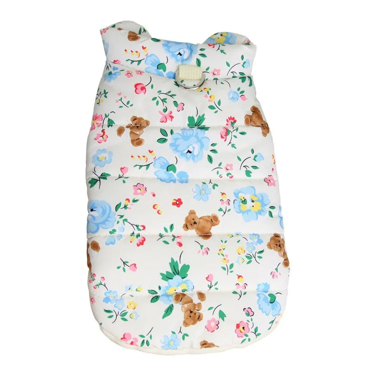 A white dog coat with a floral and teddy bear print, displayed flat, showing the entire design.