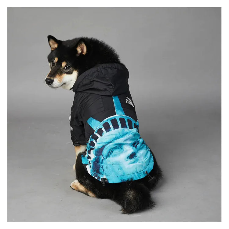 Dog wearing American Apparel Dog Hoodie in black and blue with a Statue of Liberty design, side view