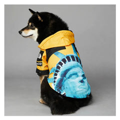 Dog wearing American Apparel Dog Hoodie in yellow with a Statue of Liberty design, back view