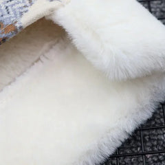 Close-up of the soft white fleece lining inside a plaid dog coat
