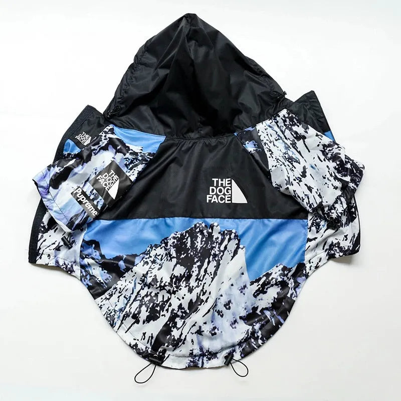 Front view of the mountain-themed blue dog hoodie by The Dog Face, laid out flat."