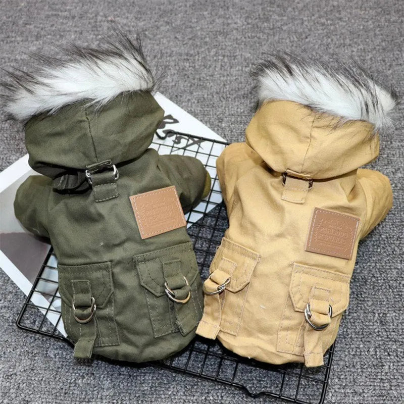 Two dog hoodies with faux fur trim and pocket details, one in green and one in tan, laid flat on a gray background