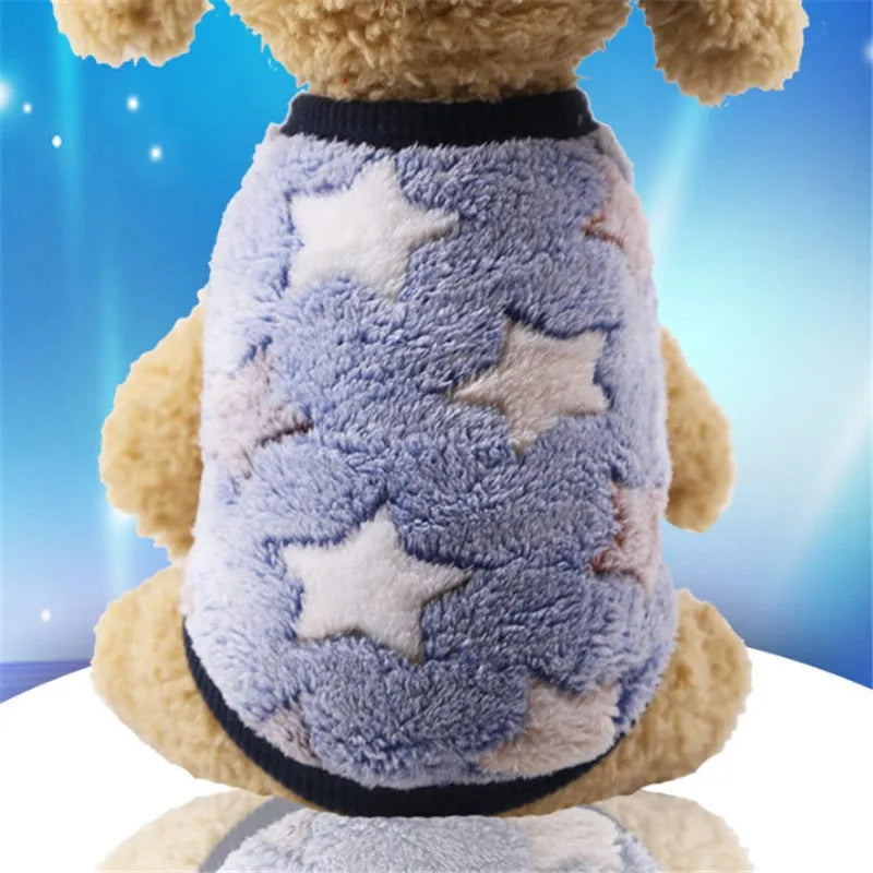 A light blue dog sweater with white stars, providing a cute and comfortable outfit for very small dogs.