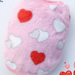 A fluffy pink dog sweater decorated with red and white hearts, ideal for showing some love and warmth to your very small dog.