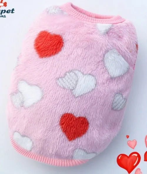 A fluffy pink dog sweater decorated with red and white hearts, ideal for showing some love and warmth to your very small dog.